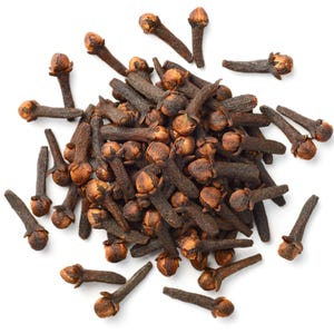 May include: A pile of whole cloves, a common spice, against a white background. The cloves are a dark brown color with a small, round bud at the top and a long, slender stem. The image is a top-down view.