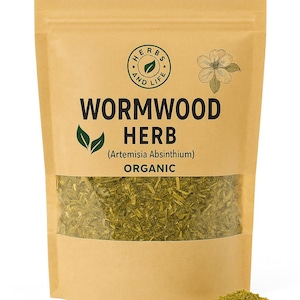May include: A brown paper bag with a transparent section showing dried wormwood herb. The bag is labelled "Wormwood Herb" and "Organic", with a circular logo and a flower illustration. The herb is green.