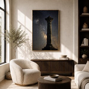 May include: A rectangular wall art print featuring a dark, silhouetted classical stone column standing against a vibrant night sky filled with stars and the glowing, hazy band of the Milky Way galaxy, framed in a thin, metallic gold border.