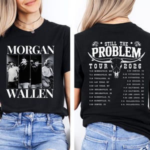 May include: Black t-shirt with a black and white image of Morgan Wallen on the front. The artist's name is printed below the image. The back of the shirt displays "Still The Problem Tour 2026" with a bull skull graphic and tour dates.
