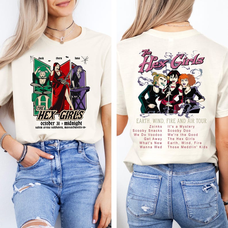 May include: Cream-colored t-shirt featuring a graphic of "The Hex Girls" band. The front design includes band members and text: "October 31 - Midnight." The back design shows the band and tour details.