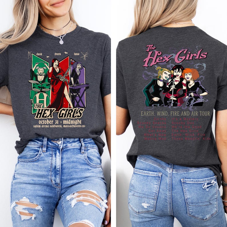 May include: Dark gray t-shirt featuring a graphic of "The Hex Girls" band. The front design includes band members and text. The back design shows the band with tour details. A Halloween-themed tee.