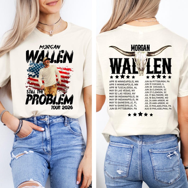 May include: Cream-colored t-shirt featuring the text "MORGAN WALLEN" above an image of a person in front of an American flag design. The text "STILL THE PROBLEM TOUR 2026" is below. The back of the shirt has the text "MORGAN WALLEN" with a bull skull graphic and tour dates.