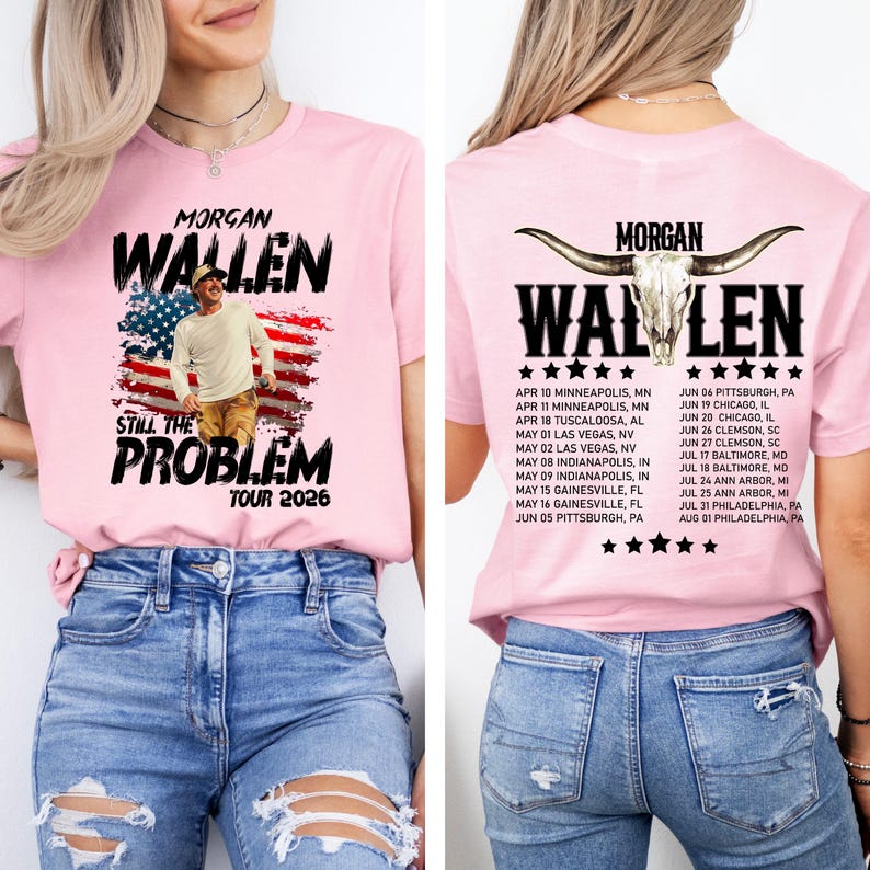 May include: Pink t-shirt featuring the text "MORGAN WALLEN" above an image of a man in front of an American flag design. The words "STILL THE PROBLEM TOUR 2026" are below. The back of the shirt has the same text and a list of tour dates.
