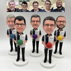 May include: A collection of bobblehead figurines, each depicting a man with glasses, holding a bowling ball. The figurines wear bowling shirts and stand on white bases. Above the figurines are photos of the men.