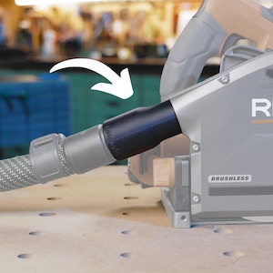 May include: A black dust collection adapter with a gray hose attached to a gray and silver power tool. The tool has the word "BRUSHLESS" printed on it.