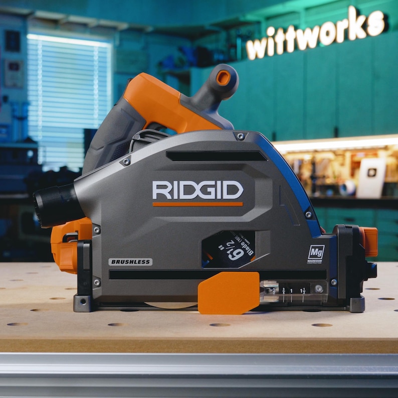 May include: A gray and orange Ridgid 9 1/2 inch circular saw with a brushless motor. The saw is on a wooden surface.