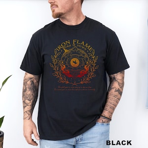 May include: Black t-shirt with a circular graphic featuring the text "IRON FLAME TURN IT DOWN" in gold. The design includes a sun, flames, and botanical elements. The shirt also has additional text at the bottom. The word "BLACK" is printed at the bottom.