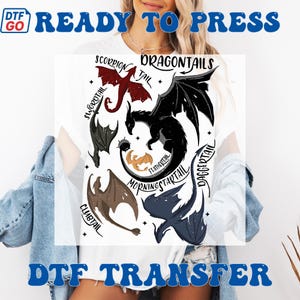 May include: White t-shirt with a DTF transfer design showcasing dragon illustrations in red, black, brown, and blue. The design includes the text "DRAGONTAILS" and other dragon tail names. The words "READY TO PRESS" and "DTF TRANSFER" are also visible.