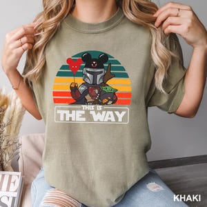 May include: A white ceramic mug with a black handle and the text "But First, Coffee" in a handwritten style. The mug is on a white surface. The mug is approximately 4 inches tall.