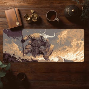 May include: A rectangular mousepad featuring a warrior in ornate armor with a horned helmet, holding a flag. The artwork is set against a backdrop of a cloudy sky and a battlefield, with shades of gold, gray, and brown.