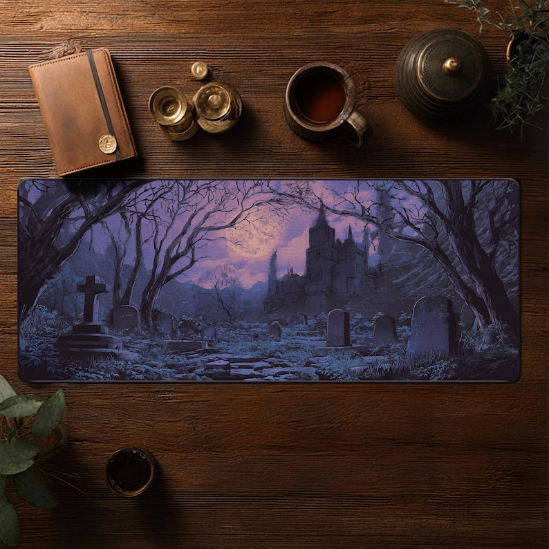 May include: A rectangular mousepad featuring a gothic graveyard scene with a full moon, a castle, and bare trees. The color palette includes shades of purple, gray, and black. A leather notebook, a cup of tea, and other items are on a wooden surface.