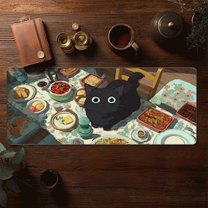 May include: A rectangular desk mat featuring a whimsical illustration of a black cat with large white eyes, set against a dining table scene. The table is laden with food, plates, and a floral tablecloth. The mat is surrounded by wooden accessories.