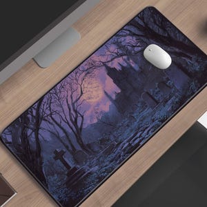 May include: A rectangular mousepad featuring a gothic graveyard scene with a full moon, bare trees, and a castle silhouette. The color palette includes shades of purple, blue, and black. A white computer mouse sits on the pad.