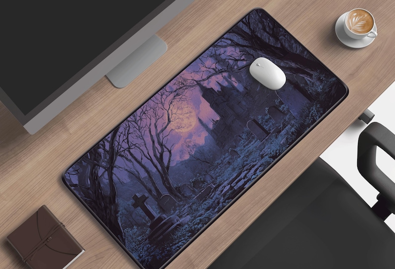 May include: A rectangular mousepad featuring a gothic graveyard scene with a full moon, bare trees, and a castle silhouette. The color palette includes shades of purple, blue, and black. A white computer mouse sits on the pad.