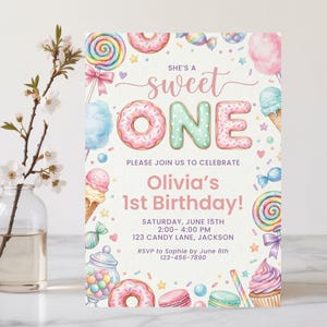 May include: A rectangular birthday invitation card featuring watercolor illustrations of donuts, lollipops, ice cream, and candy. The text reads: She's a sweet ONE, Please join us to celebrate, Olivia's 1st Birthday, Saturday, June 15th, 2:00-4:00 PM, 123 Candy Lane, Jackson, RSVP to Sophie by June 6th 123-456-7890.