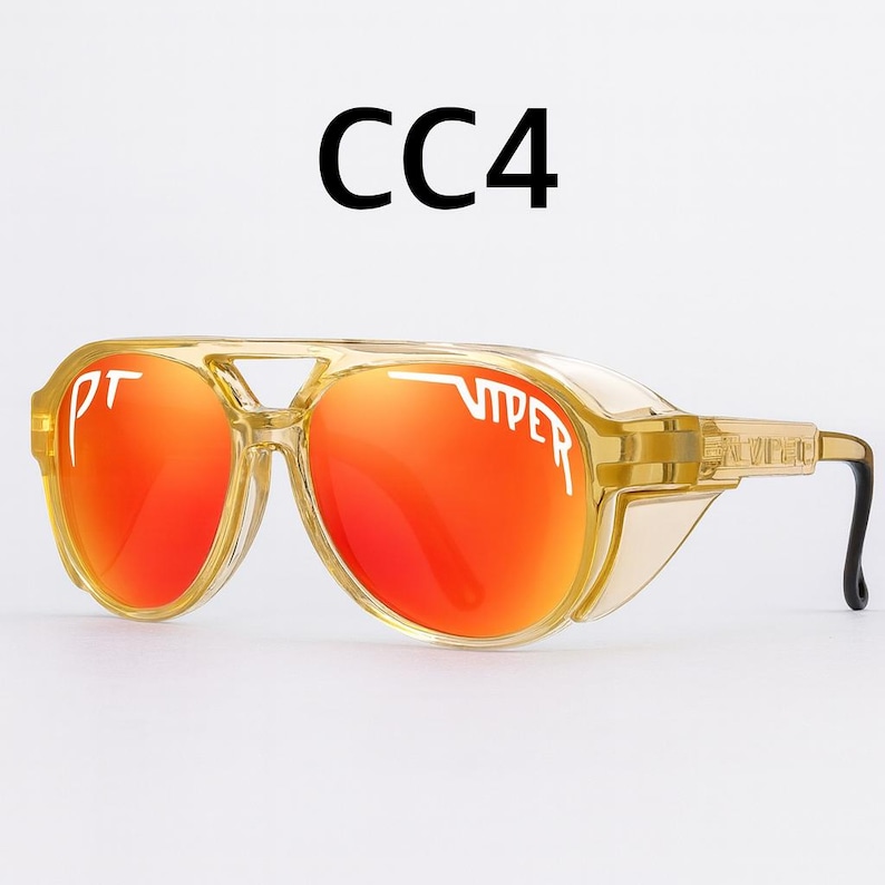 Puede incluir: Gafas de sol transparentes estilo aviador con lentes naranjas. Las gafas tienen una montura dorada y el texto "VIPER" est&aacute; impreso en la lente. El texto "CC4" est&aacute; impreso encima de las gafas.