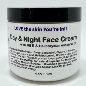 May include: A white cylindrical jar with a black lid containing Day & Night Face Cream with Vit E & Helichrysum essential oil. The label text reads LOVE the skin You're in!! and lists ingredients, manufacturer Bon Logic, and 4 oz/118 ml volume.