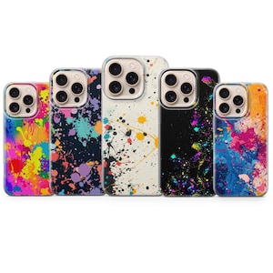 May include: Five phone cases with colorful paint splatter designs. The cases feature a variety of colors, including pink, yellow, blue, purple, and black. Each case has a clear border and a camera cutout.