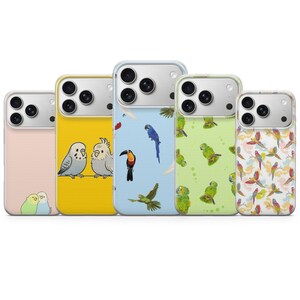 May include: Five phone cases with bird illustrations. The cases display parrots, toucans, and other birds on backgrounds of yellow, blue, and pink. The cases are designed to fit a smartphone.
