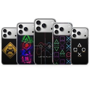 May include: Five phone cases with gaming-themed designs. The cases feature a black background with colorful graphics of game controllers, shapes, and the words "Gamer Zone" and "Let's Play". The cases are designed for a smartphone.