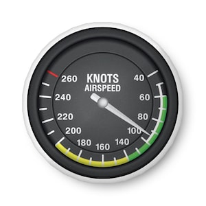 May include: A round airspeed indicator with a black face and white markings. The gauge reads "KNOTS AIRSPEED" and displays a needle pointing to 100 knots. The dial has a white border and a green and yellow arc.
