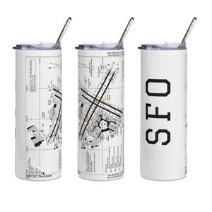 May include: White travel tumbler with a silver straw, featuring an airport diagram design. The tumbler has a black lid and the letters "SFO" in bold black font. The design includes detailed maps and text.