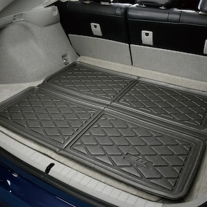 May include: Black, diamond-patterned car trunk mats. The mats are made of a durable material and are designed to protect the vehicle's interior. The mats are shown installed in the trunk of a car, providing a protective layer.
