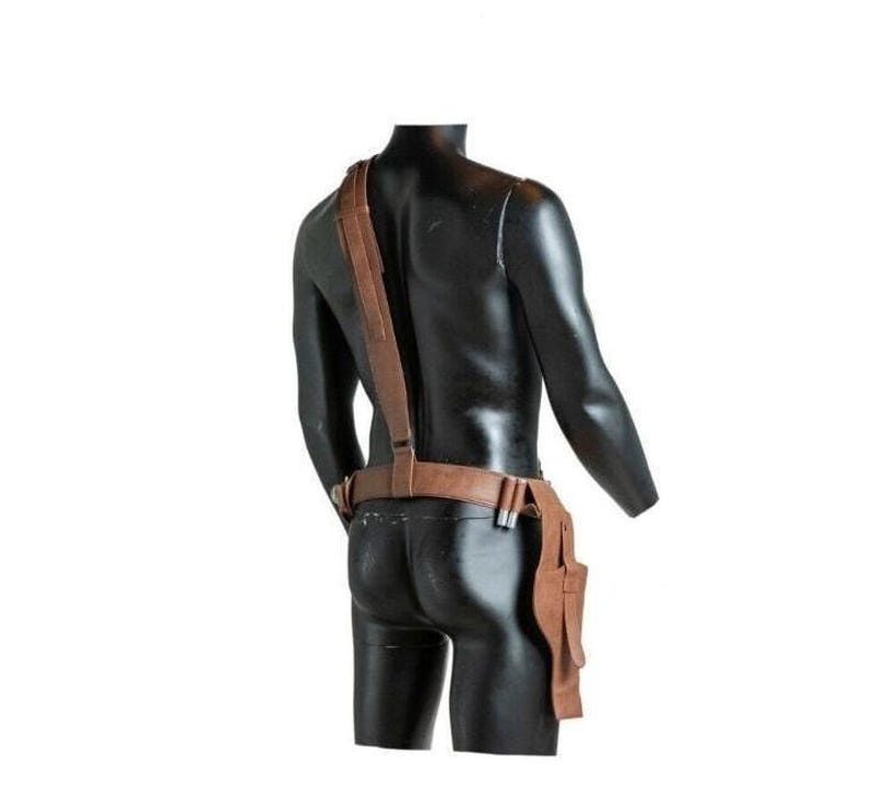 May include: A brown leather holster system featuring a waist belt and a single shoulder strap. The belt includes a side-mounted holster pouch and two small cylindrical loops for holding items. The leather has a smooth, matte finish throughout.