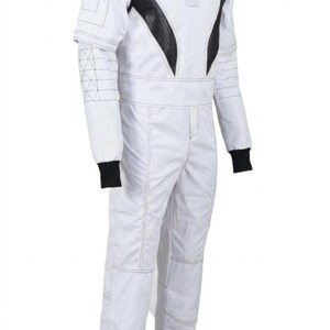 May include: White jumpsuit with black accents on the shoulders and chest. The suit features black cuffs and a high collar. Stitching details are visible throughout the garment, and the suit appears to be made of a durable material.