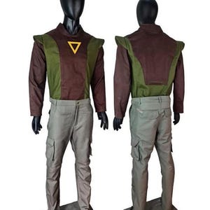 May include: A two-piece outfit consisting of a long-sleeved shirt and cargo pants. The shirt features a brown and olive green color-blocked design with a yellow triangle emblem on the chest. The pants are light gray with side cargo pockets.