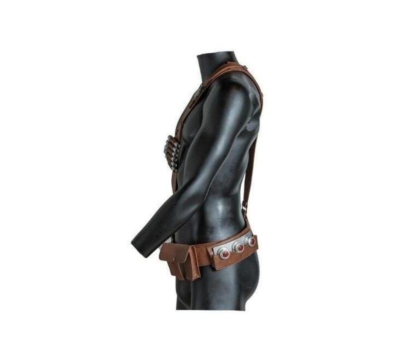 May include: A brown leather harness and belt set worn on a black mannequin torso. The harness features a chest-mounted ammunition holder, while the belt includes a rectangular pouch and three circular silver-toned metal accents with red centers.