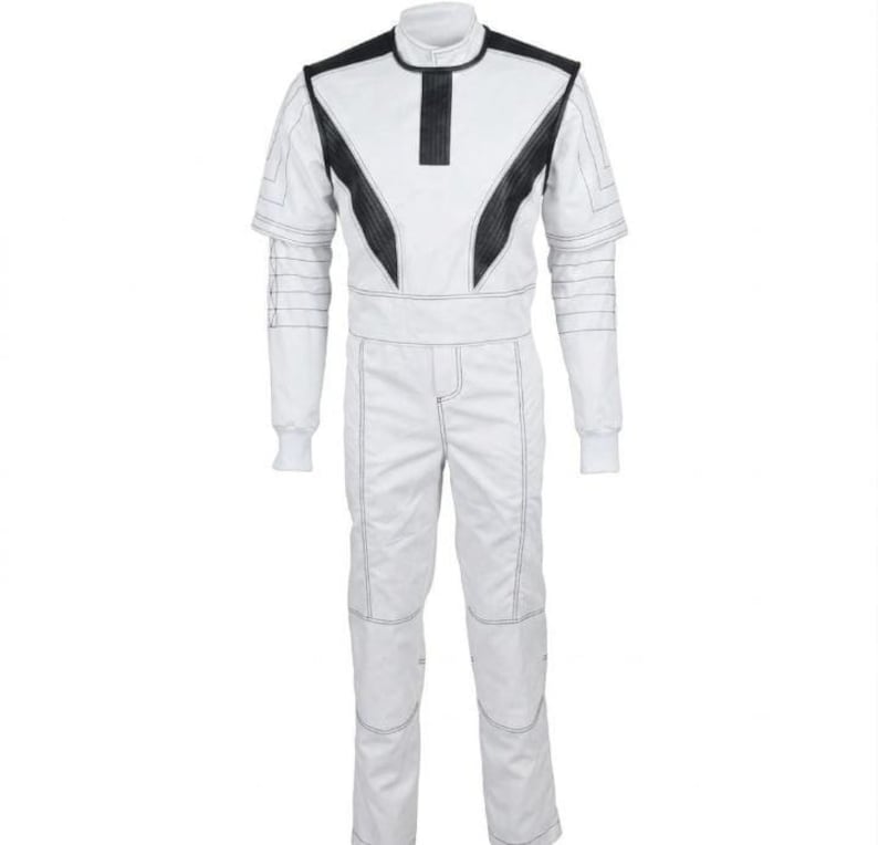 May include: White racing suit with black accents on the shoulders and chest. The suit features a high collar, long sleeves, and matching pants. The suit has visible stitching details and is designed for motorsports.