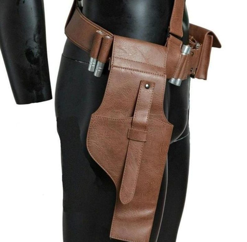 May include: A brown textured utility belt featuring a holster with a vertical strap and silver-toned cylindrical accents attached to the side. The belt includes a side pouch and is worn around the waist, constructed from a durable material.