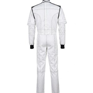 May include: White racing suit with black accents. The suit features black trim around the collar and shoulders, with black cuffs at the wrists. The suit has a geometric design on the upper arms and is stitched with white thread.