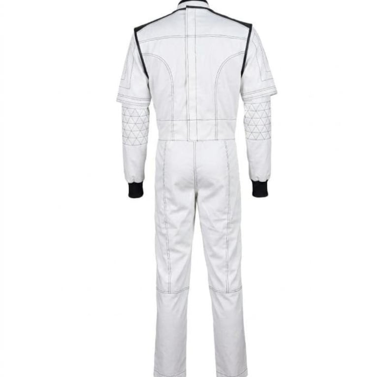 May include: White racing suit with black accents. The suit features black trim around the collar and shoulders, with black cuffs at the wrists. The suit has a geometric design on the upper arms and is stitched with white thread.