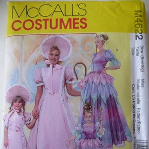 May include: A sewing pattern for a fairy costume. The pattern includes three different styles: a long, pink dress with a white collar and puffed sleeves, a shorter, pink dress with a white collar and puffed sleeves, and a long, purple dress with a white collar and puffed sleeves. The pattern is for sizes small to extra large.