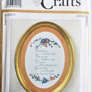May include: A white oval-shaped embroidery pattern with a gold frame. The pattern features a quote about friendship and flowers. The quote reads: "Friendship is a priceless gift that can't be bought or sold. To have an understanding friend is worth far more than gold. The Helen Steiner Rice Foundation."
