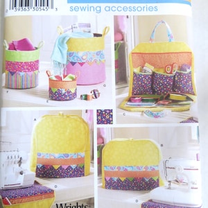 May include: Simplicity sewing accessories pattern featuring various fabric storage baskets, a sewing kit, and a sewing machine cover. The items are in yellow, pink, and purple with colorful patterned fabric accents. The pattern includes the text "Fat Quarter Club".