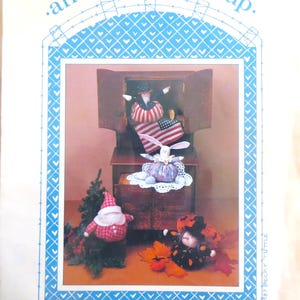 May include: A craft pattern for making holiday-themed potpourri dolls. The pattern includes instructions for making a Santa, a turkey, a bunny, and a witch. The pattern is titled "Holiday Potpourri" and is part of the "On A Roll Series".