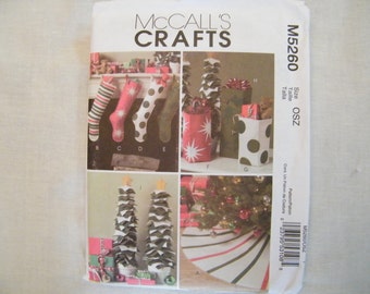 May include: A McCall's Crafts sewing pattern for making Christmas decorations. The pattern includes instructions for making stockings, gift bags, and a tree skirt. The pattern number is M5260.
