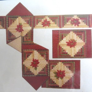 May include: A festive quilt pattern with a poinsettia motif. The design incorporates red and beige hues, with a central poinsettia flower in each block. The pattern includes different block sizes and shapes, ideal for a Christmas-themed sewing project.