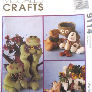 May include: A sewing pattern for making a frog, a dog, a cat, and a dog bowl. The pattern is from McCall's Crafts and the pattern number is 9114. The pattern includes instructions for making a frog, a dog, a cat, and a dog bowl.