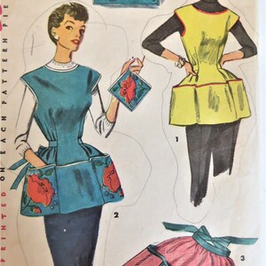 May include: A vintage sewing pattern for three different apron styles. The first apron is blue with red floral accents, the second is yellow with a red trim, and the third is pink with a green trim. The pattern is printed on paper and includes instructions for sewing each apron.