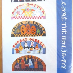 May include: Five colourful wooden signs with different holiday themes. The signs are shaped like half circles and feature various illustrations and text. The signs are titled "Star Spangled Summer", "Happy Easter", "Trick or Treat", "Gobble Gobble", and "Alleluia".