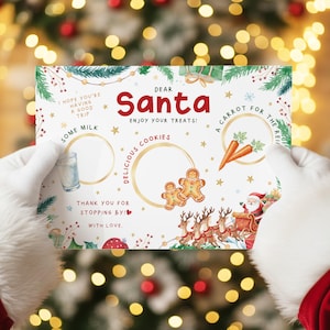 May include: A festive Christmas-themed card held by gloved hands, featuring the words "Dear Santa" in red. The card includes spaces for milk, cookies, and carrots, with illustrations of gingerbread men, carrots, and Santa's sleigh.