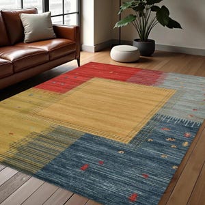 May include: A rectangular area rug with a geometric pattern in shades of red, yellow, blue, and gray. The rug features a central yellow square surrounded by other colored rectangular sections. The rug is placed on a hardwood floor.