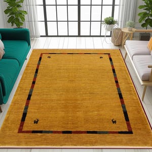 May include: Mustard yellow area rug with a rectangular design. The rug has a dark red border and a patterned border with black, red, and green stripes. Small animal figures are in each corner. The rug is placed in a living room setting.
