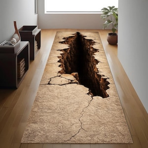 Peut inclure: Un tapis rectangulaire avec une illusion 3D d'un profond gouffre. Le tapis présente une surface fissurée de couleur beige avec une ouverture sombre et caverneuse au centre. Le design crée un effet dramatique et accrocheur.