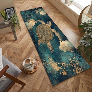 May include: A rectangular rug with a teal and gold turtle design. The rug features a large turtle with intricate gold detailing, set against a teal background with gold accents. White cloud-like shapes are also present.